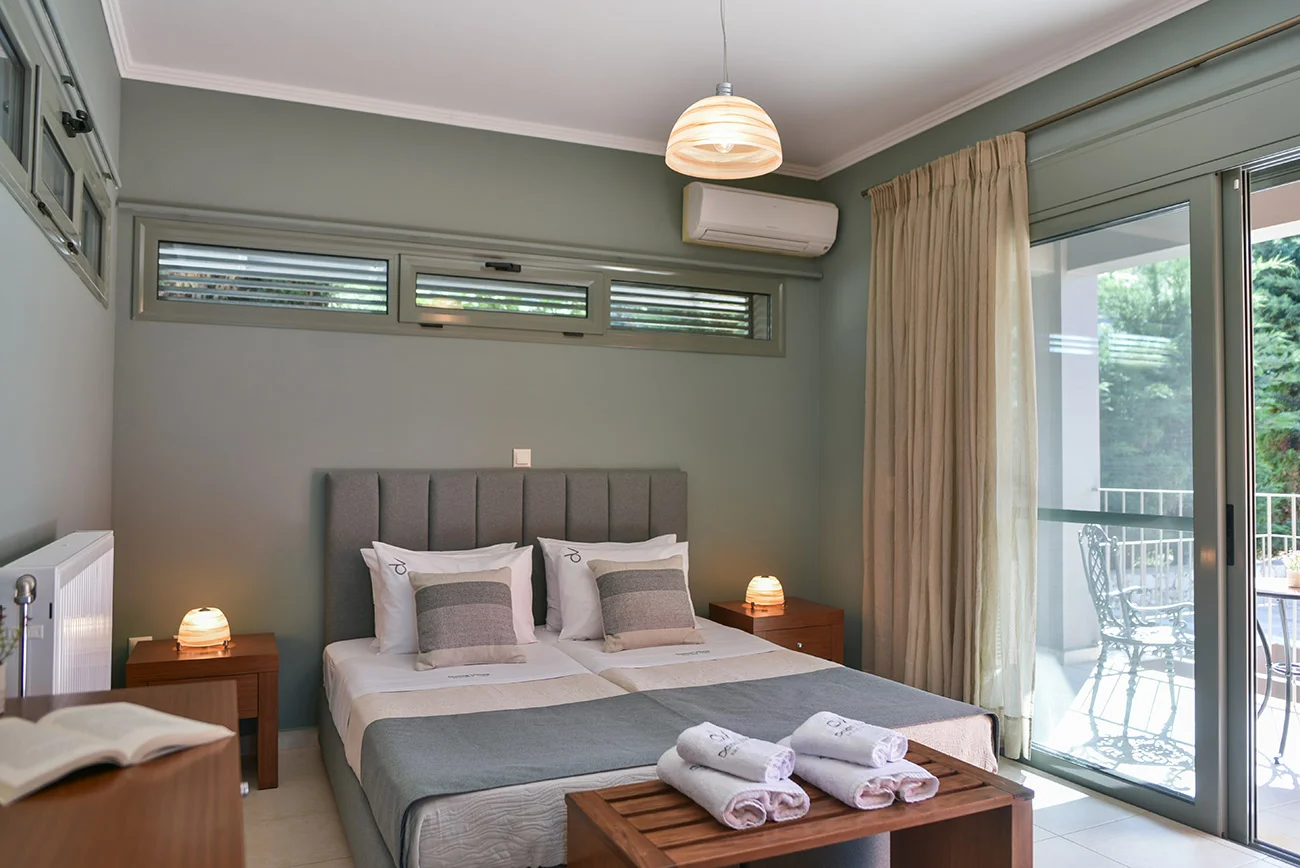 Bright bedroom with garden views at Villa Skala Acqua
